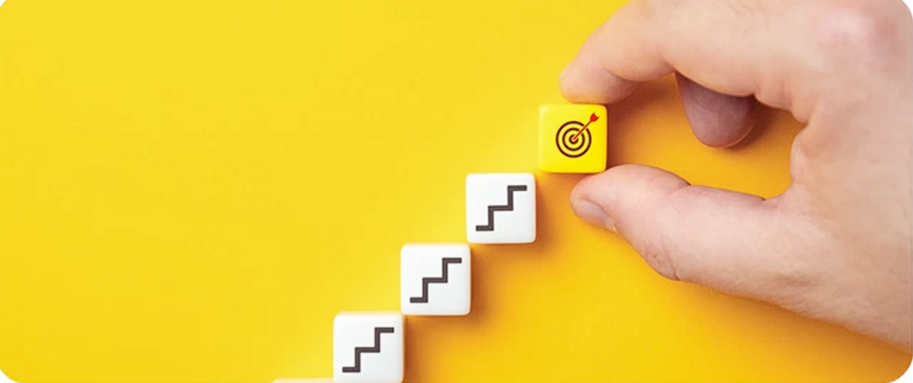 A hand placing a target marker on ascending implementation steps